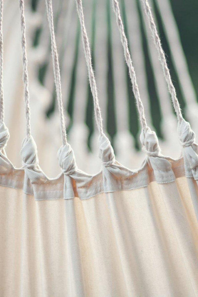 vue détaillée des suspentes d'une chaise hamac suspendue en macrame beige avec des perles en bois claires 
